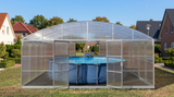 A large arched pool enclosure with transparent panels and a metal frame, enclosing an above-ground swimming pool in a backyard setting.